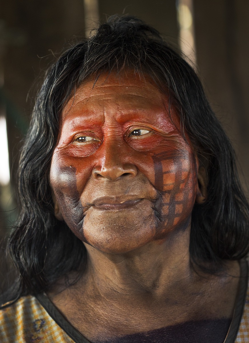 Portrait of a Xikrin elder with red and black face paint